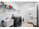 Efficient laundry room featuring modern washer and dryer, a sink, and ample shelving at 17199 Hickory Wind Dr, Clermont, FL 34711
