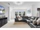 Inviting living room with a sectional sofa and large windows providing ample natural light at 17199 Hickory Wind Dr, Clermont, FL 34711