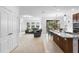 Open floor plan: view from living room shows stylish kitchen, and dining area with a sliding door at 17199 Hickory Wind Dr, Clermont, FL 34711