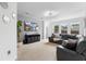 Bright and airy living room with a mounted TV and large windows with backyard views at 17199 Hickory Wind Dr, Clermont, FL 34711