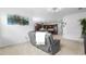 Open-concept living room showcasing the adjacent kitchen with stainless steel appliances and modern finishes at 17199 Hickory Wind Dr, Clermont, FL 34711