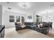 Spacious living room featuring a large sectional sofa and sliding glass doors at 17199 Hickory Wind Dr, Clermont, FL 34711