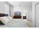Relaxing main bedroom with a full bed, TV atop a dresser, and adjoining bathroom at 17199 Hickory Wind Dr, Clermont, FL 34711
