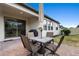 Outdoor patio space with a table, four chairs, umbrella, and a grill at 17199 Hickory Wind Dr, Clermont, FL 34711