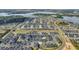 Extensive aerial view of a residential neighborhood, showcasing many homes and multiple lakes at 17333 Hickory Wind Dr, Clermont, FL 34711