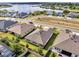 Aerial view of a community homes with a lake in the background on a sunny day at 17333 Hickory Wind Dr, Clermont, FL 34711