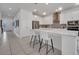 Modern kitchen featuring stainless steel appliances, granite countertops, and a spacious island with seating at 17333 Hickory Wind Dr, Clermont, FL 34711