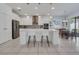 Bright kitchen with stainless steel appliances, a spacious island, and stylish pendant lighting above it at 17333 Hickory Wind Dr, Clermont, FL 34711