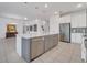 Open concept kitchen with an island, stainless appliances, and bright lighting at 17333 Hickory Wind Dr, Clermont, FL 34711