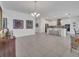 Open concept view of the living room and kitchen with neutral color palette and tiled floors at 17333 Hickory Wind Dr, Clermont, FL 34711