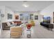 Spacious living room with modern decor, large windows, tiled floors, and a comfortable seating area at 17333 Hickory Wind Dr, Clermont, FL 34711