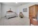 Tranquil bedroom featuring tiled floors, a comfortable bed, and an accent armoire at 17333 Hickory Wind Dr, Clermont, FL 34711