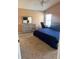 Spacious bedroom with neutral tones, a comfortable bed, dresser, and a desk by the window, ideal for relaxation and work at 17517 Silver Creek Ct, Clermont, FL 34714