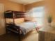 Cozy bedroom with a bunk bed, a window and carpeted flooring at 17517 Silver Creek Ct, Clermont, FL 34714