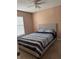 Comfortable bedroom featuring a soft bedding, a window and carpeted flooring at 17517 Silver Creek Ct, Clermont, FL 34714