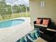 Relaxing screened-in patio area featuring outdoor seating and a view of the pool and backyard space at 17517 Silver Creek Ct, Clermont, FL 34714