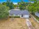 An elevated view shows a well-kept home with a manicured lawn and white picket fence at 181 Ada Ave, Orange City, FL 32763