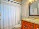 Bathroom featuring a shower/tub combination, decorative mirror, and charming vanity with granite countertop at 181 Ada Ave, Orange City, FL 32763