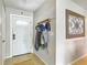 Bright foyer with tile flooring, a decorative wall hanging, and a coat rack at 181 Ada Ave, Orange City, FL 32763