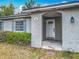 Welcoming entryway featuring a white door, textured walls, and stylish wall decor at 181 Ada Ave, Orange City, FL 32763