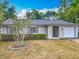Charming single-story home featuring a well-maintained lawn and attached one-car garage at 181 Ada Ave, Orange City, FL 32763