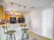 Kitchen with breakfast bar, wooden cabinets, modern appliances, and closet at 181 Ada Ave, Orange City, FL 32763