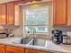 Kitchen featuring granite countertops, wooden cabinets, and stainless steel sink at 181 Ada Ave, Orange City, FL 32763
