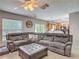 Relaxing living room with tile flooring, a ceiling fan, and an oversized sectional sofa at 181 Ada Ave, Orange City, FL 32763