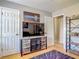 Cozy living room with TV stand, decorative shelving, and a modern purple rug at 181 Ada Ave, Orange City, FL 32763