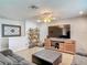 Comfortable living room featuring a large TV, decorative shelving, and plush seating at 181 Ada Ave, Orange City, FL 32763