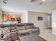 Spacious living room with tile flooring, an open floor plan, and a comfortable sectional sofa at 181 Ada Ave, Orange City, FL 32763