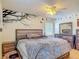 Inviting bedroom featuring a large bed, matching nightstands, and decorative bird wall art at 181 Ada Ave, Orange City, FL 32763
