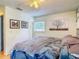 Comfortable bedroom with ceiling fan, soft lighting, and decorative artwork above the bed at 181 Ada Ave, Orange City, FL 32763