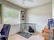 Bright office space featuring a dog in a cage, a large window, and neutral wall colors at 181 Ada Ave, Orange City, FL 32763