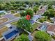 Picture of a home with mature trees, enclosed pool, and solar panels on the roof of the neighboring house at 1816 Haperon St, Apopka, FL 32703