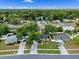 Aerial view of a home and neighborhood with mature trees and a well-manicured lawn at 1816 Haperon St, Apopka, FL 32703