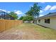 Fenced in backyard for a single Gathering home with lush green grass and mature trees at 1816 Haperon St, Apopka, FL 32703
