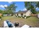 A spacious backyard with a seating area, lush green grass, and tasteful landscaping at 1816 Haperon St, Apopka, FL 32703