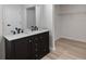 Bright bathroom featuring a dual vanity with marble countertop, black fixtures, and a walk-in closet at 1816 Haperon St, Apopka, FL 32703