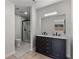 Elegant bathroom featuring a dual sink vanity, a walk-in shower with glass, and a toilet at 1816 Haperon St, Apopka, FL 32703