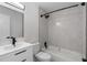 Modern bathroom featuring a sleek vanity, new shower with black hardware, and tiled bathtub at 1816 Haperon St, Apopka, FL 32703