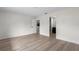 Minimalist bedroom with two open doorways offering views of a kitchen and a bathroom at 1816 Haperon St, Apopka, FL 32703