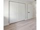 Bedroom with standard bi-fold closet with doors closed and open doorway at 1816 Haperon St, Apopka, FL 32703