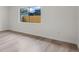 Bright bedroom with a window view of the backyard fence, complemented by wood-look floors at 1816 Haperon St, Apopka, FL 32703