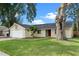 Charming single-story home featuring a red front door, a two-car garage and a well-maintained front yard at 1816 Haperon St, Apopka, FL 32703
