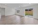 Bright, neutrally-toned living room featuring sleek flooring, recessed lighting, and sliding glass doors at 1816 Haperon St, Apopka, FL 32703