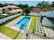 Aerial view of the backyard featuring a sparkling pool, patio, and lush landscaping at 182 N Phelps Ave, Winter Park, FL 32789
