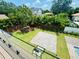 Green backyard featuring mature trees, grass, a deck, and an outdoor living space at 182 N Phelps Ave, Winter Park, FL 32789