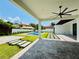 Expansive backyard with a sparkling pool, lush landscaping, and a covered patio at 182 N Phelps Ave, Winter Park, FL 32789