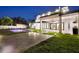 Backyard pool at dusk with outdoor kitchen and travertine pavers at 182 N Phelps Ave, Winter Park, FL 32789